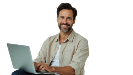 Diverse people advertisement headshot: A smiling man with a beard sits comfortably using a laptop while looking directly at the camera.