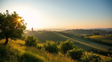 Fototapeta premium Breathtaking Sunrise Over Rolling Tuscan Hills with Towering Bell Tower in the Distance