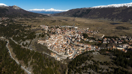 Naklejka premium Aerial view of Ovindoli, a small town located in the province of L'Aquila, in Abruzzo, Italy. It is a popular winter resort in the Apennines. In the background is the Gran Sasso mountain range.