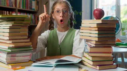 Funny adorable thoughtful Caucasian little girl child school kid schoolgirl in glasses student...
