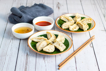 Momo are steamed or fried dumplings filled with meat or vegetables, popular in Nepal, Tibet, and Bhutan, served with spicy chutney.