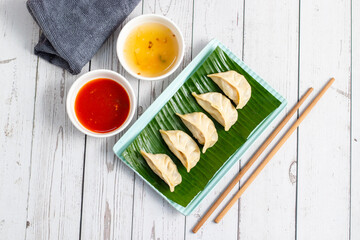 Momo are steamed or fried dumplings filled with meat or vegetables, popular in Nepal, Tibet, and...