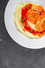 Fish dish tomato sauce and mashed potatoe tasty fresh gourmet food background table rustic food top view copy space