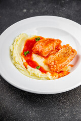 Fish dish tomato sauce and mashed potatoe tasty fresh gourmet food background table rustic food top view copy space