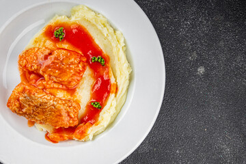 Fish dish tomato sauce and mashed potatoe tasty fresh gourmet food background table rustic food top view copy space