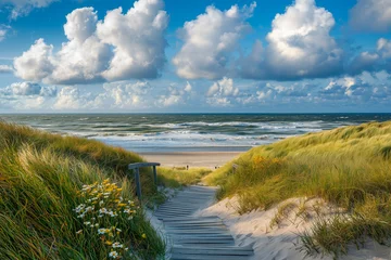 Fototapete North Sea coast during the day with blue skies, waves, and grassy dunes © agrus_aiart
