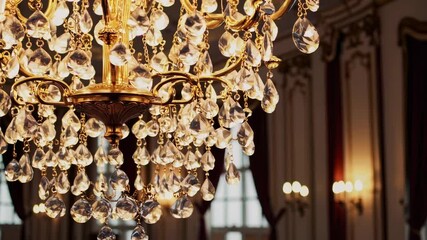 Opulent crystal chandeliers illuminate elegant ballroom in grand interior scene