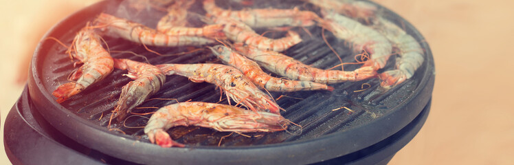 Cooking shrimp grill. Street food, picnic on the beach. Delicious prawn on grill. Large prawns grilled.