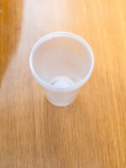 above view of empty plastic cup on table close up