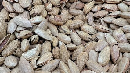 Slightly open almond shells lie scattered.