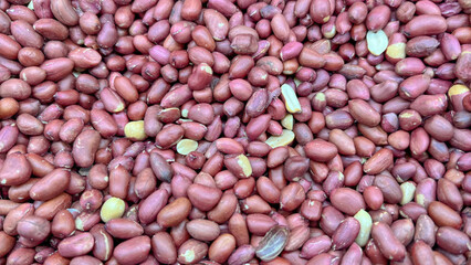 Roasted pistachio nuts are scattered around in large quantities.