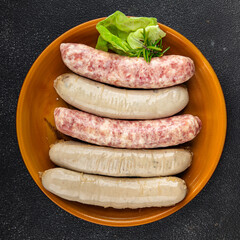 Sausages raw meat pork, beef, chicken, lamb fresh tasty food dish gourmet food background on the table rustic food top view copy space
