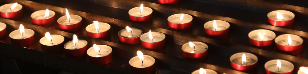 lit votive candles in place of worship
