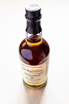 Moscow, Russia - March 5, 2025: standing bottle of The Balvenie single malt scotch whisky on light brown wooden board