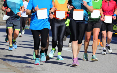 legs also with sporty leggings with many male and female amateur and non professional runners...