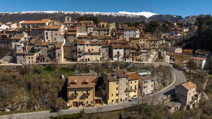 Obraz premium Aerial view of historic center of Ovindoli, a town located in the province of L'Aquila, in Abruzzo, Italy. It is a popular winter resort in the Apennines. In background is the Velino mountain range.