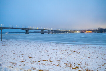 Obraz premium bank of frozen river and bridge in Kostroma city