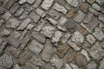 Antique cobblestone road surface criss-cross.