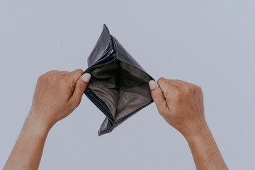 Man hand open an empty wallet on white background. Poverty and financial loss concept.