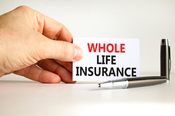 Whole life insurance symbol. Concept words Whole life insurance on beautiful white card. Beautiful white background. Businessman hand. Business whole life insurance concept. Copy space.