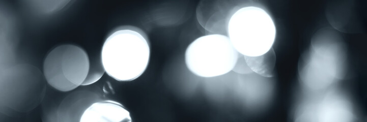 Blurred lights, gray, deep blue background, banner texture. Abstract bokeh with soft light header. Wide screen wallpaper. Panoramic web banner with copy space for design