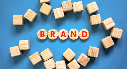 Brand symbol. Concept word Brand on beautiful wooden circles. Beautiful blue table blue background....