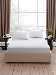 An elegant double bed with snow-white sheets, pillows and two bedside tables, in front of a large window with brown curtains, in a bedroom with wooden floors. Front view photo. Suitable for mockup