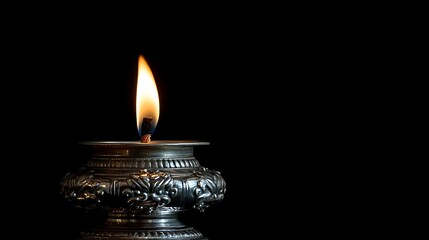 Fototapeta premium Ornate Silver Oil Lamp with Burning Flame on Black Background