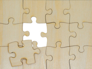 wooden jigsaw puzzle forming a rectangle; problem solving, teamwork and strategy concept