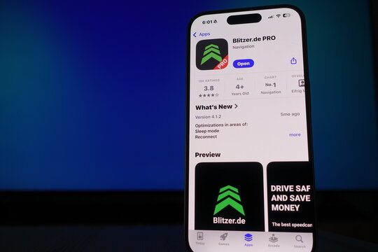 Kiel, SH, Germany March 17 2025 A smartphone sits in front of a blue ambient screen highlighting the Blitzer.de Pro app, designed for navigation and route optimization for drivers