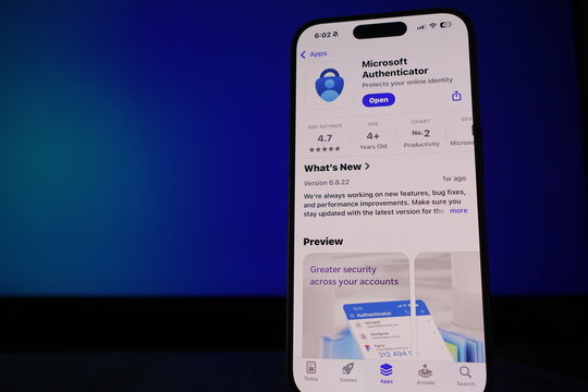 Kiel, SH, Germany March 17 2025: Smartphone showcasing Microsoft Authenticator app in front of a blue ambient screen emphasizing online security and productivity tools available for users