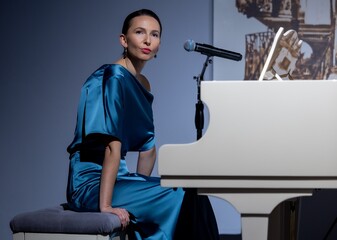 Talented pianist, beautiful woman, performer plays white grand piano