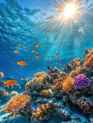 Obraz premium Vibrant underwater coral reef ecosystem teeming with orange fish under the bright sun rays creating a serene aquatic scene