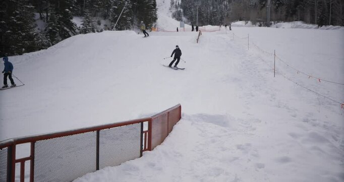 Masked skier doing awesome skid on rail then falling into snow - epic slow motion