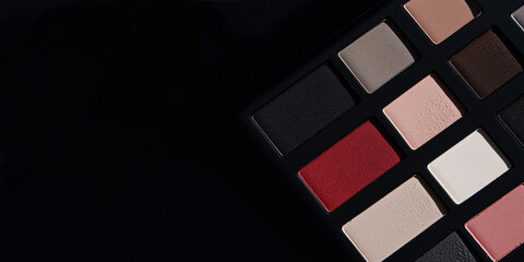 Palette of Colors: An elegant makeup palette arranged artfully on a dark surface, showcasing a rich spectrum of colors and textures for eyes
