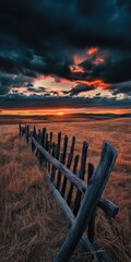 Obraz premium Sunset over a rustic wooden fence in a field