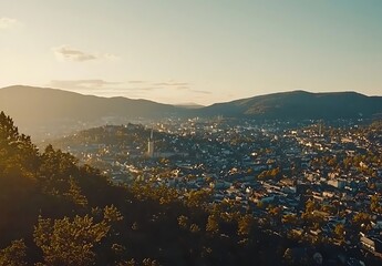 Naklejka premium View of cityscape in golden light from hillside; travel or tourism background