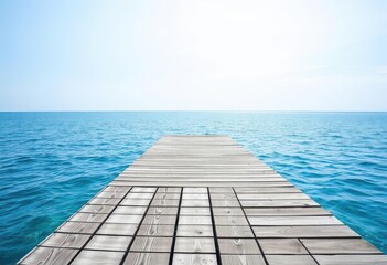 Fototapeta premium Gray weathered wooden pier deck extends over calm blue summer sea under a bright sky, coastal, day