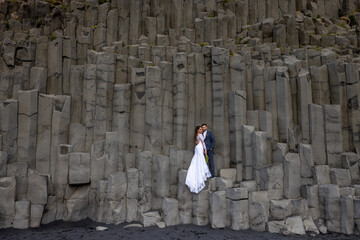 A breathtaking and unforgettable wedding unfolds beautifully on Reynisfjara Black Sand Beach, showcasing the unique basalt columns along with the stunning and remarkable natural beauty of Iceland