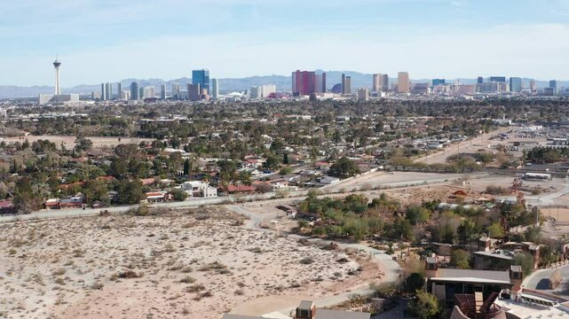 Aerial drone view of Las Vegas city skyline with residential homes and trees 01