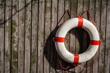 Lifebuoy on the wooden wall of a barn.
