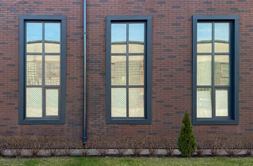 Brick facade with three rectangular windows