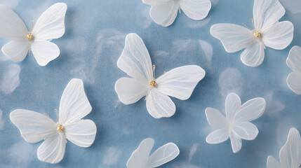 Collection of white butterflies n a blue textured background.