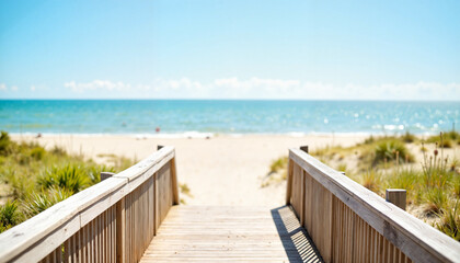 Inviting boardwalk leads to sandy beach under clear skies, vacation bliss