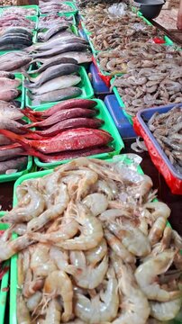Traders sell mackerel, catfish, red snapper, shrimp, squid and several other freshwater fish to buyers who are bargaining for fish to buy at the traditional market.