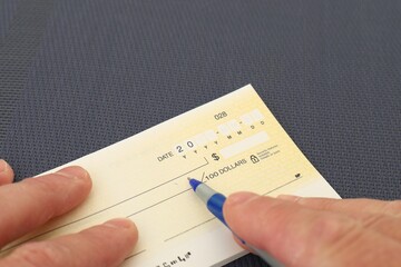 hand signing a bank check