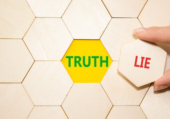 Truth or Lie symbol. Concept word Truth or Lie on wooden puzzle. Businessman hand. Beautiful yellow...