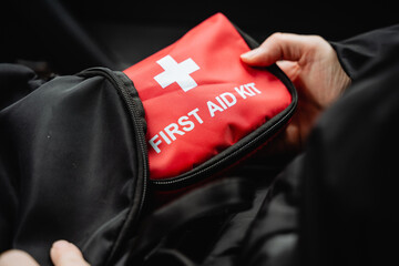 A person is carrying a meticulously organized and wellprepared first aid kit, ready to provide...