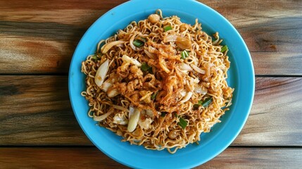Fried instant noodle with garlic and onion on blue plate