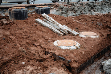 A sizable pile of dirt, mixed with several pieces of wood and other materials, can be seen at the...